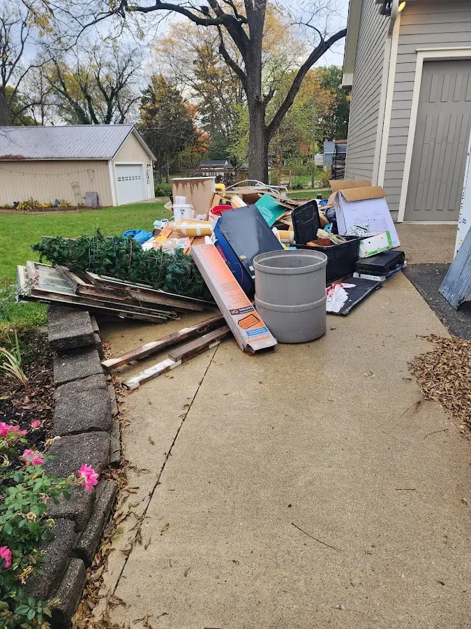 Dumpster being loaded with debris for Roofing Dumpster Rental in Longview